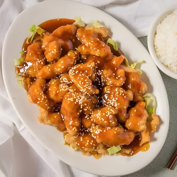 D. Fong's Chinese Cuisine's sesame chicken with sauce and sesame seeds, served with white rice.