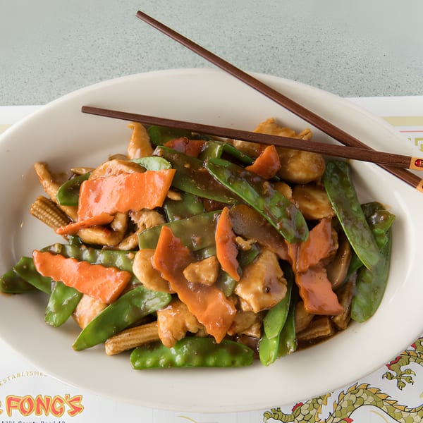 D. Fong's Chinese Cuisine's chicken stir-fry with snow peas, carrots, and baby corn, served with chopsticks.